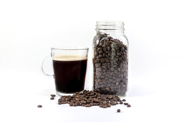 Whole coffee beans stored in an airtight glass jar
