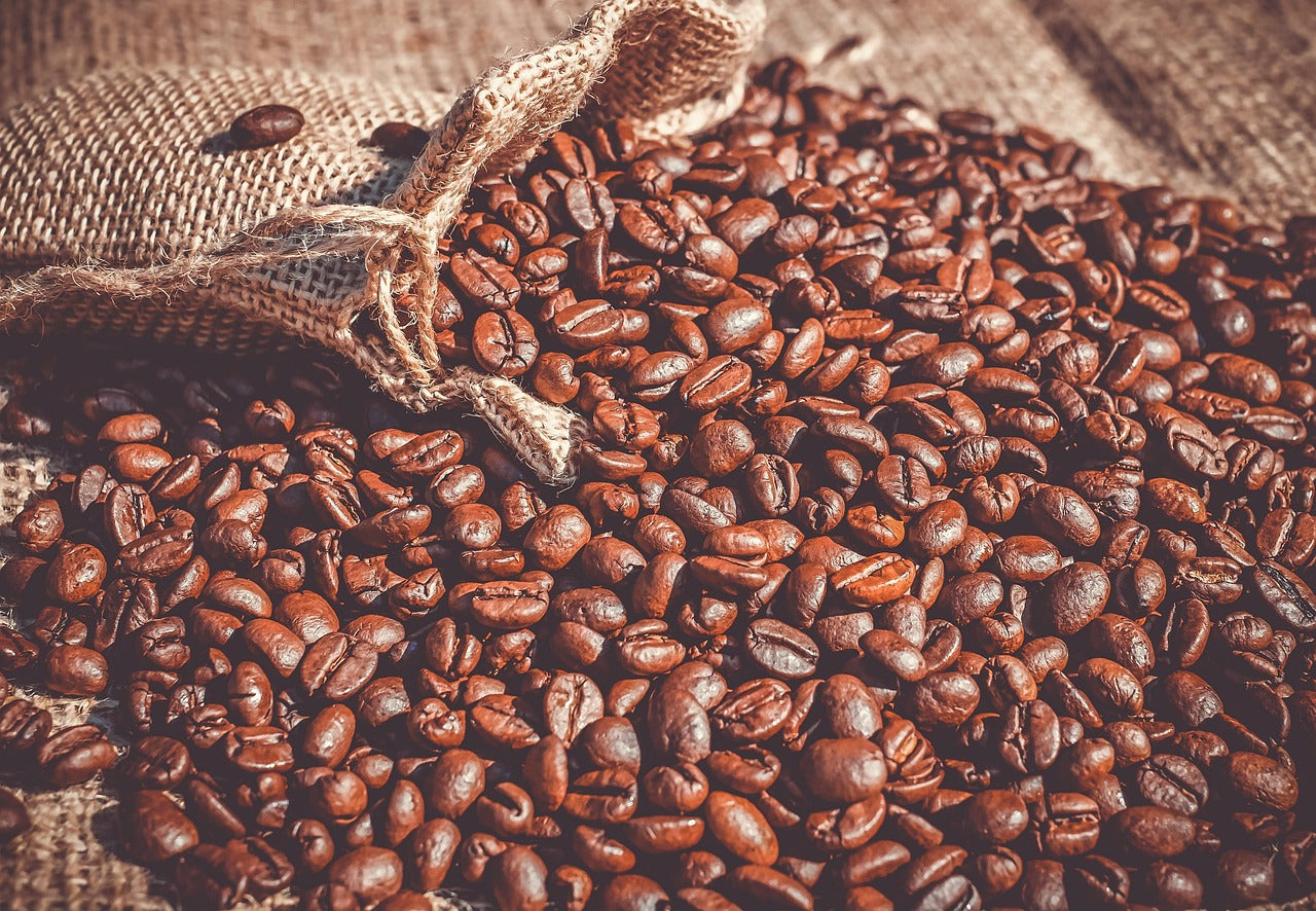 Freshly roasted coffee beans in a delivery bag on a wooden table