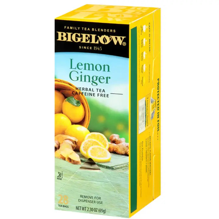 Bigelow Lemon Ginger herbal tea box with bright yellow and warm tones representing lemon and ginger, 20 tea bags on white background.
